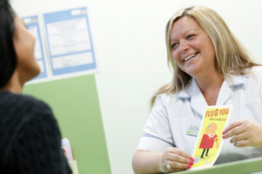 Medical professional handing information to a student at the Hertfordshire University medical centre